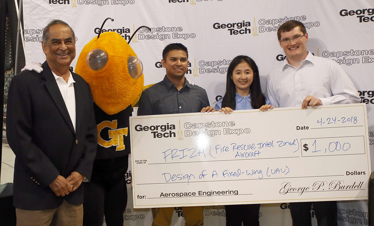 AE prof. Lakshmi Sankar joins three members of the TEAM Firenza as they accept their check 