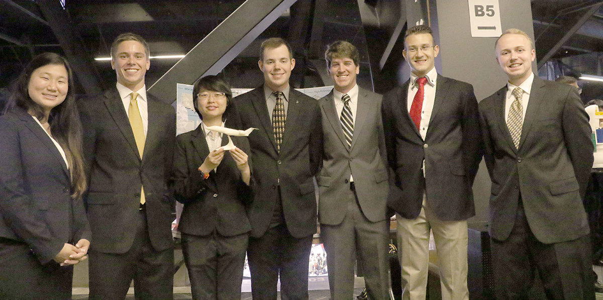 Team Coronis with a model of their design