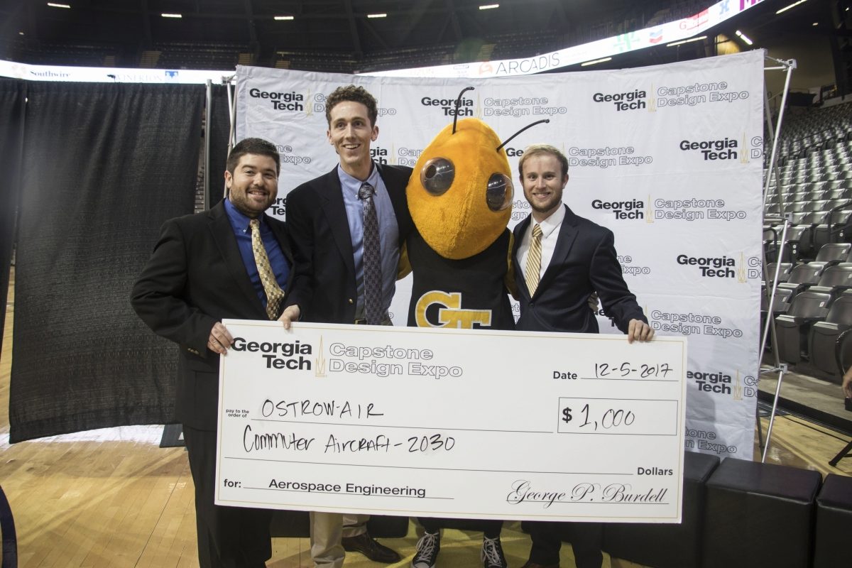 Members of the Ostrow Air team pose with Buzz while accepting their $1000 prize money