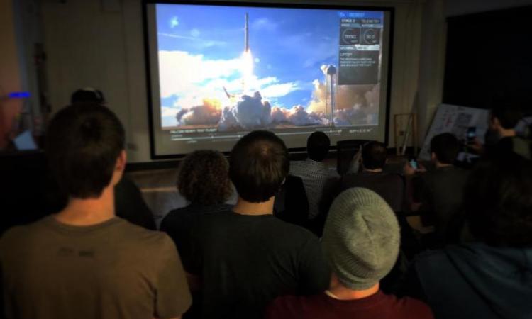 <p>A livestream of the Falcon Heavy launch is projected on a wall-to-wall, floor-to-ceiling screen in the Engineering, Science and Mechanics Building on February 6.</p>