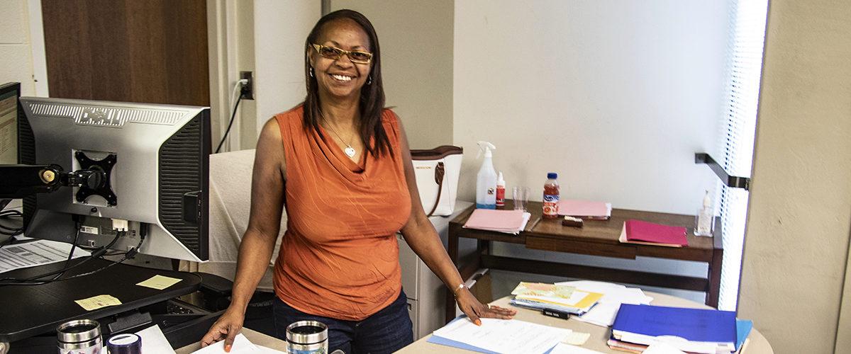 Holding Down the Fort. Sadie Marshall, financial administrator III, at her desk in the Business Office of the Daniel Guggenheim School